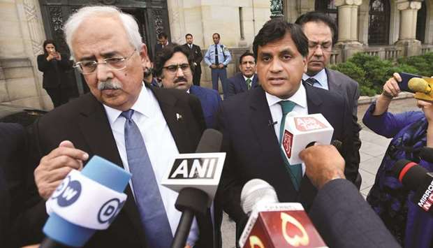 Pakistan Attorney-General Anwar Mansoor and diplomat Mohamed Faisal are seen outside the International Court of Justice after the issue of a verdict in the case of Indian national Kulbhushan Jadhav, who was sentenced to death by Pakistan in 2017, in The Hague, Netherlands, yesterday.