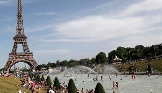 People bathe in the Trocadero Fountain near the Eiffel Tower in Paris during a heatwave on June 28. AFP