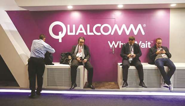 Visitors check their mobile devices outside the Qualcomm pavilion at the Mobile World Congress in Barcelona (file).