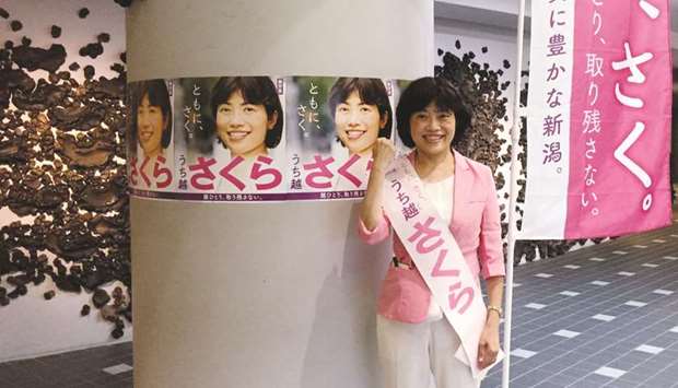 Sakura Uchikoshi, an opposition candidate for Japanu2019s upcoming July 21 upper house election, poses in front of election posters in Mitsuke, Niigata, Japan, on July 9.
