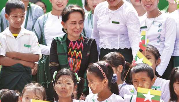 Myanmar State Counsellor Aung San Suu Kyi attends a ceremony with teachers and students for a new school in Kawhmu yesterday.