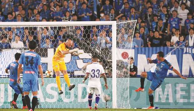 Kawasaki Frontaleu2019s Leandro Damiao (R) scores against Chelsea in Yokohama yesterday.