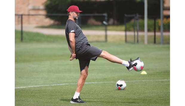 Liverpool F.C. manager Jurgen Klopp kicks the ball during a practice session at Notre Dame Stadium in South Bend, Indiana.