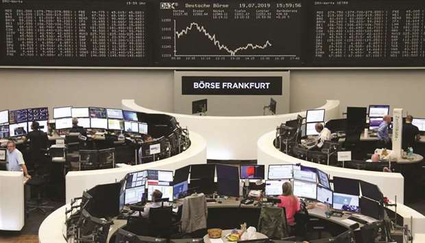 Traders work at the Frankfurt Stock Exchange. The DAX 30 closed up 0.3% to 12,260.07 points yesterday.