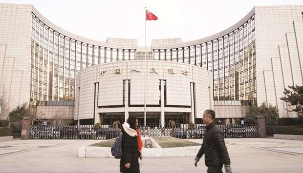 Pedestrians walk past the Peopleu2019s Bank of China headquarters in Beijing. The PBoC reportedly told banks recently to stop cutting mortgage rates, amid concerns about the risks of a property bubble.