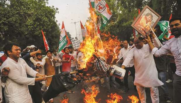 Congress Party supporters burn an effigy during a protest in New Delhi yesterday against the stopping of Priyanka Gandhi Vadra from visiting a village where tribal people were gunned down this week over a land dispute.