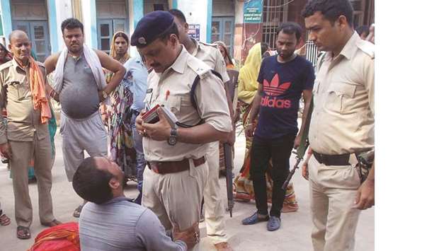 A relative of the victims of a mob lynching incident speaks to a police officer outside a hospital in Chapra, Bihar, yesterday.