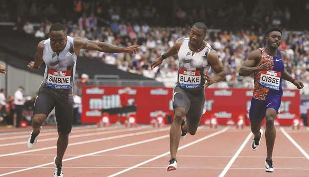 South Africau2019s Akani Simbine (left) crosses the line to win the menu2019s 100m at the IAAF Diamond League meeting in London yesterday. (AFP)