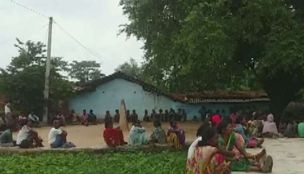 Villagers gather at the scene of killings