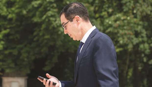 Steven Mnuchin, US Treasury secretary, checks his mobile phone at the Group of Seven (G-7) finance ministers and central bank governors meeting in Chantilly, France, on Thursday.