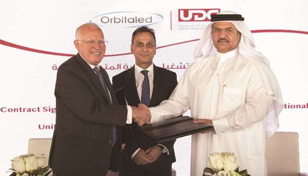 Ibrahim Jassim al-Othman and Kevin McNeany after signing the agreement to operate United School International, in the presence of Ajay Sharma.