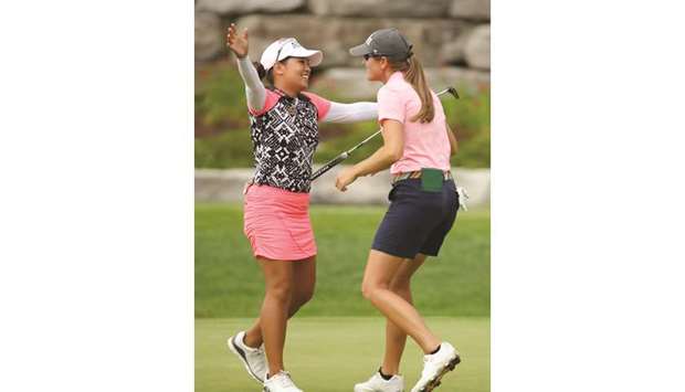 Cydney Clanton of the United States (R) and Jasmine Suwannapura of Thailand celebrate on the 18th green after winning the Dow Great Lakes Bay Invitational at Midland Country Club in Midland, Michigan.
