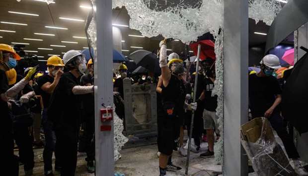 This picture taken yesterday shows protesters smashing glass doors and windows of the government headquarters in Hong Kong on the 22nd anniversary of the city's handover from Britain to China.