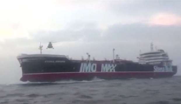 A helicopter hovers over British-flagged tanker Stena Impero near the strait of Hormuz on July 19, in this still image taken from video