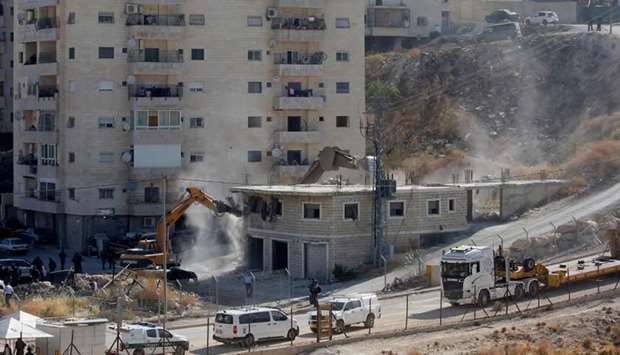 Israeli security forces tearing down one of the Palestinian buildings still under construction in the Wadi al-Hummus area adjacent to the Palestinian village of Sur Baher in East Jerusalem.