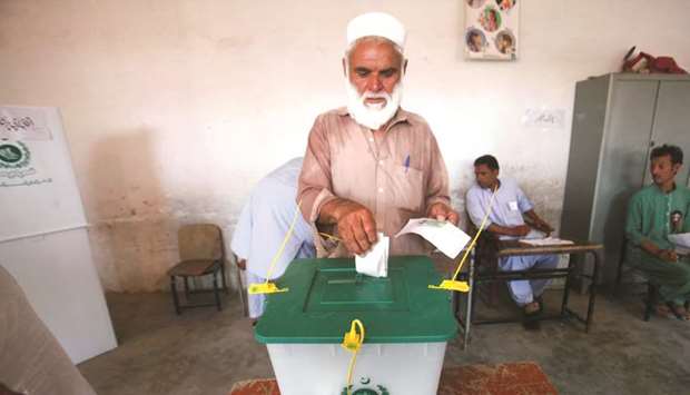 This picture taken on Saturday shows a man casting his vote at a polling station in Jamrud.