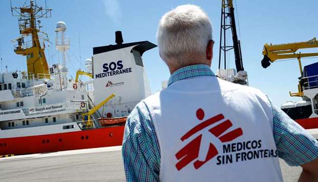 This file photo taken last year shows a member of Doctors Without Borders (MSF) in front of the Aquarius rescue vessel, chartered by French NGO SOS-Mediterranee and Doctors Without Borders (MSF), docked at the port of Valencia before the shipu2019s departure. SOS Mediterranee said yesterday that it has relaunched migrant rescue operations off Libya, seven months after it was forced to abandon efforts using the Aquarius.