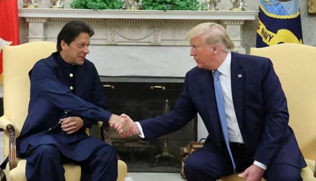 Pakistanu2019s Prime Minister Imran Khan shakes hands with US President Donald Trump at the start of their meeting in the Oval Office of the White House in Washington