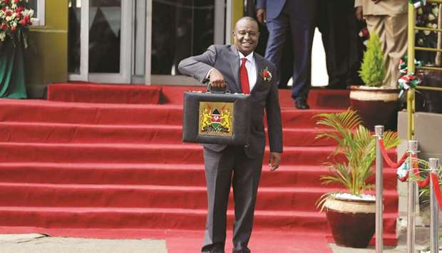 Kenyan Finance Minister Henry Rotich holds up a briefcase containing the Government Budget for the 2019/20 fiscal year in Nairobi on June 13, 2019.