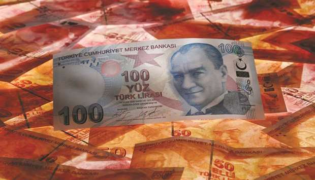 A 100 Turkish lira banknote is seen on top of 50 lira banknotes in this picture illustration in Istanbul (file). The lira has rallied more than 7%, too, including a 2.8% leap on Monday.