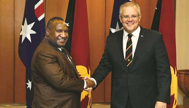 Australiau2019s Prime Minister Scott Morrison, right, greets Papua New Guineau2019s Prime Minister James Marape at Parliament House in Canberra yesterday.