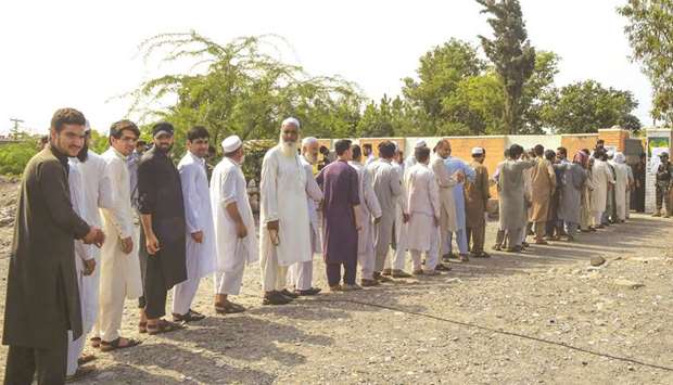 This picture taken on Saturday shows tribesmen lining up to cast their vote for the first provincial elections, outside a polling station in Jamrud, a town in Khyber Pakhtunkhwa.