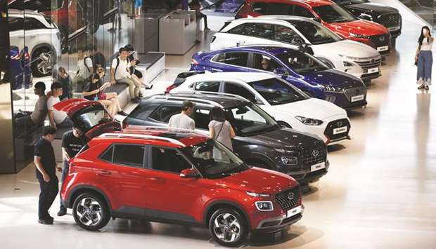 Customers look at Hyundai Motor vehicles on display at the companyu2019s Motorstudio showroom in Goyang, South Korea.