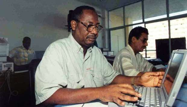 AFP correspondent in Gambia Deyda Hydara (front) works next to AFP correspondent in Mauritania Hademine Ould Sady (R) during a training at the AFP office in Dakar, Senegal. File photo taken on November 10, 1999