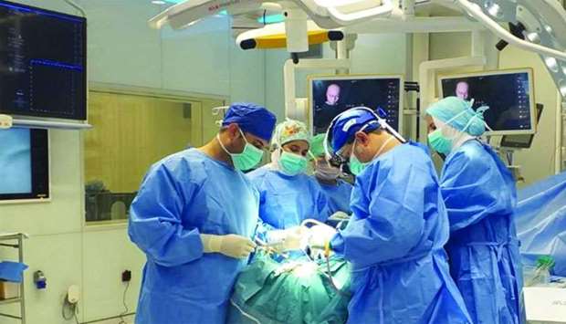 Surgeons at Hamad General Hospital performing the surgery.rnrn