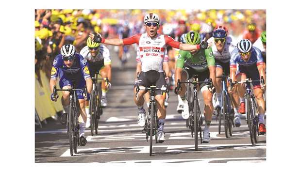 Australiau2019s Caleb Ewan (centre) celebrates as he crosses the finish line of the sixteenth stage of the 106th edition of the Tour de France in Nimes yesterday. (AFP)