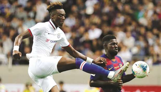 Chelseau2019s Tammy Abraham (left) in action with Barcelonau2019s Samuel Umtiti during a pre-season friendly in Saitama, Japan, yesterday. (Reuters)