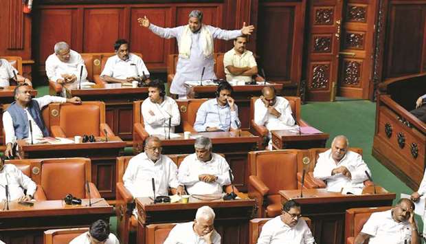 Former Karnataka chief minister and Congress leader Siddaramaiah (top centre) addresses the state legislative assembly in Bengaluru yesterday as Chief Minister H D Kumaraswamy (front row right) and other leaders look on during a trust vote yesterday.