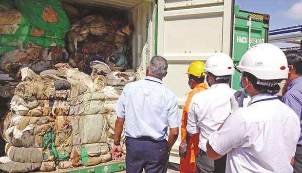 Customs officials inspect the load of a container at a port in Colombo yesterday.
