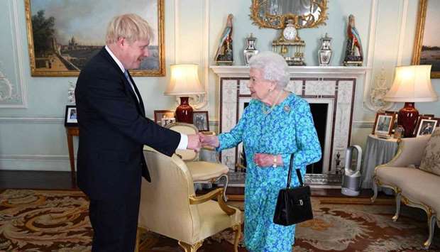 Britain's Queen Elizabeth II welcomes newly elected leader of the Conservative party, Boris Johnson during an audience in Buckingham Palace, London