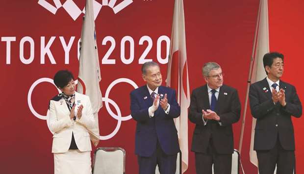 (From left to right) Tokyo governor Yuriko Koike, Tokyo 2020 Organising Committee president Yoshiro Mori, International Olympic Committee president Thomas Bach, and Japanese prime minister Shinzo Abe applaud onstage as they attend a ceremony marking one year before the start of the Tokyao 2020 Olympic Games in Tokyo yesterday. (AFP)