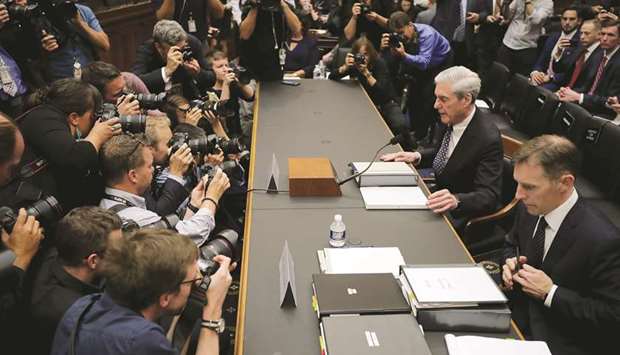 Former special counsel Robert Mueller and former deputy special counsel Aaron Zebley prepare to testify before the House Intelligence Committee in the Rayburn House Office Building in Washington, DC.