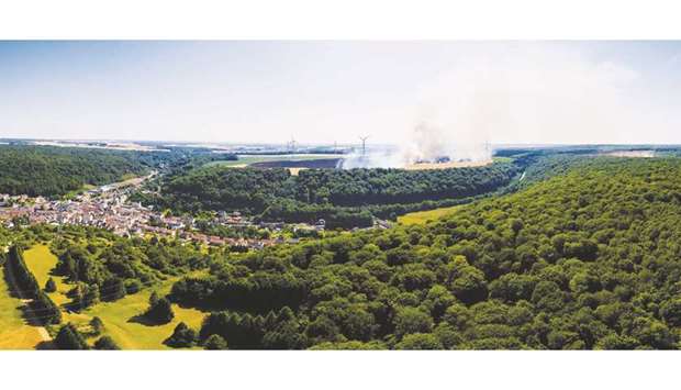 This panoramic image created by stitching together photographs shows an aerial view of a thatch fire in Ottange, eastern France. Fires ravaged several thousand hectares of crops and vegetation in Normandy, in the Centre, the Hauts-de-France, and in Lorraine under the combined effect of the heatwave and drought, according to prefectures and firefighters.