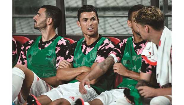 Juventusu2019s star forward Cristiano Ronaldo (centre) sits on the team bench prior to a friendly match against a K League all-star team in Seoul, South Korea, yesterday.