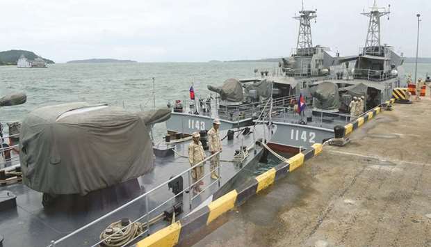 Cambodian naval personnel are seen on boats berthed at a jetty at the Ream naval base in Preah Sihanouk province yesterday during a government organised media tour.