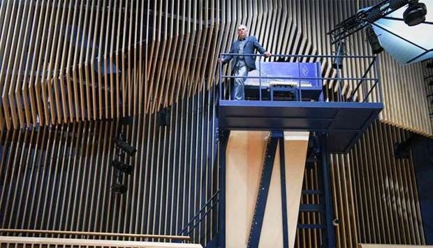 Piano constructor and builder David Klavins stands next to his new creation, the M470i vertical concert grand piano, with a height of 4,70 meters, at the new ,Lativa, concert hall in Ventspils, Latvia