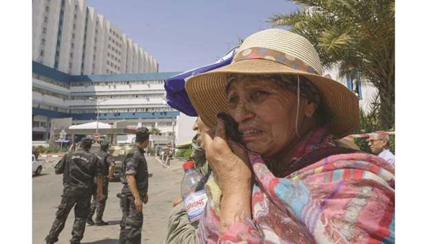 A Tunisian woman reacts as the convoy carrying the body of former president Beji Caid Essebsi leaves the military hospital in Tunis yesterday.