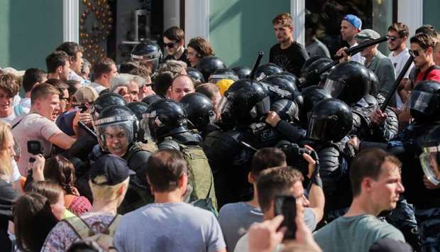 Law enforcement officers block participants of a rally calling for opposition candidates to be registered for elections to Moscow City Duma, the capital's regional parliament, in Moscow. Reuters
