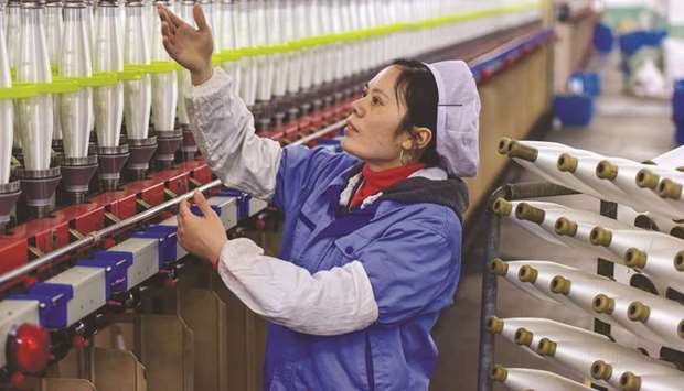 An employee works at a textile factory in Wuyi, Zhejiang province.