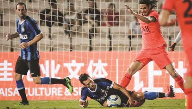 Paris St Germainu2019s Edinson Cavani (right) vies for the ball with Inter Milanu2019s Sebastiano Esposito during the International Super Cup match in Macau yesterday. (AFP)