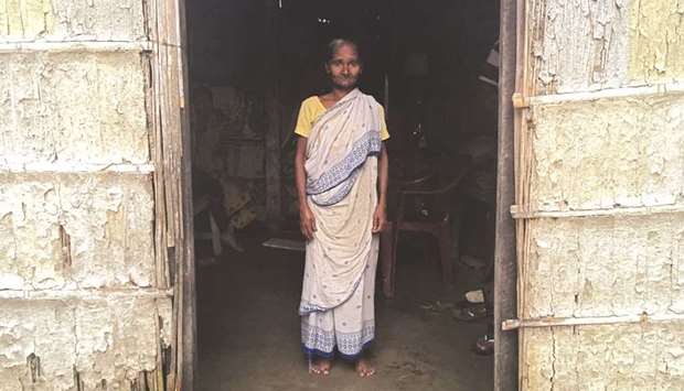 Madhubala Mandal, 59, poses for a photograph inside her bamboo hut in Bishnupur village in the northeastern state of Assam, India, on July 10.