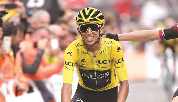 Egan Bernal (left) of Colombia is congratulated by his Team Ineos teammate Geraint Thomas of Great Britain as he crosses the finish line of the 20th stage of the Tour de France in Val Thorens, France, yesterday. (AFP)