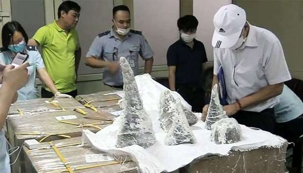 Customs officials at Noi Bai International Airport removing smuggled rhino horn pieces from packaging in Hanoi