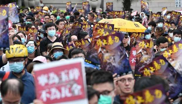 Protesters take part in a demonstration against what activists say is police violence in Hong Kong