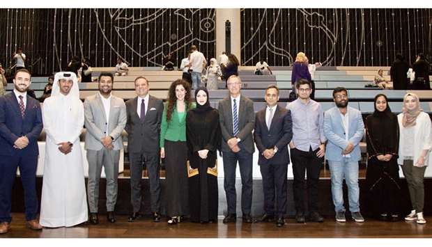 GROUP: Global Shapers Doha Hub and AYCM Qatar members with the guest of honour Ajay Sharma, Ambassador of Britain to Qatar, fifth from right; Carlos Hernandez, Ambassador of Argentina to Qatar, fourth from left; and Sheikha Alaanoud bint Hamad al-Thani, centre.
