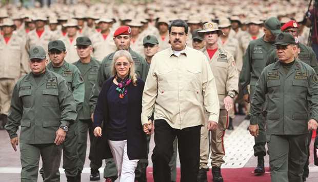 Venezuelau2019s President Nicolas Maduro walks next to his wife Cilia Flores during a ceremony with Venezuelan militia members in Caracas, Venezuela.